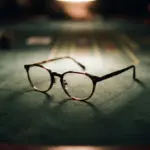 Tortoiseshell eyeglasses sit on a green felt casino table surface